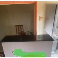 Neatly Used Reception Table with Thick Glass Top