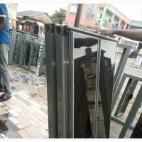 Frameless Windows With Grey Profiles and Dark Glass